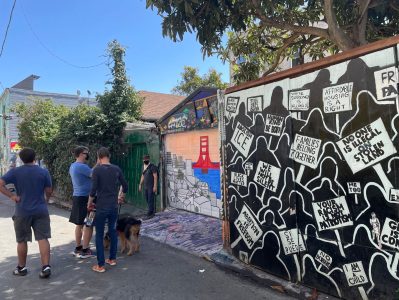 People viewing murals in the Mission