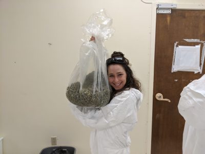A woman holding an enormous bag of weed